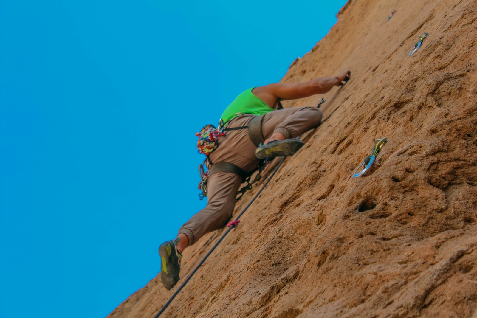 a man climbing up the side of a mountain